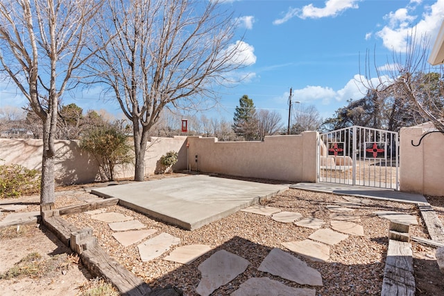 view of patio / terrace with a fenced front yard and a gate