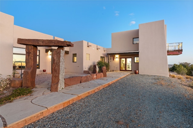 view of front of property with french doors, a patio, and stucco siding