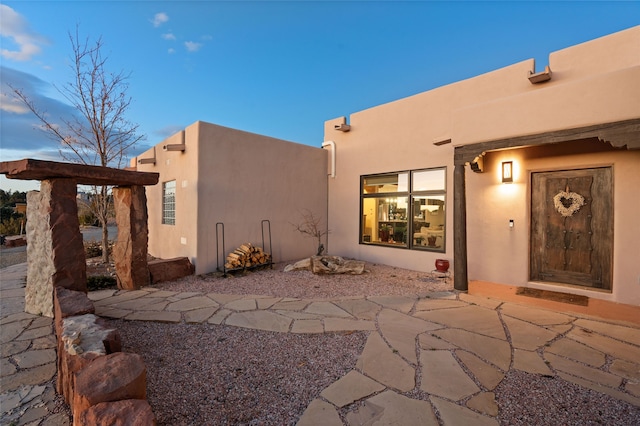 exterior space with a patio and stucco siding