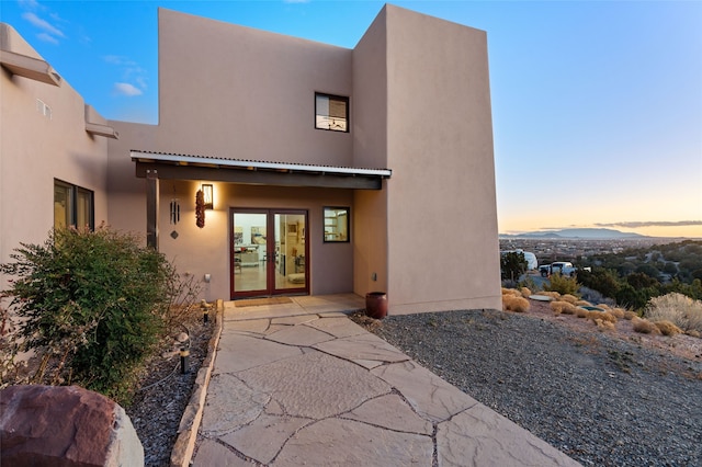 back of property featuring a patio area and stucco siding