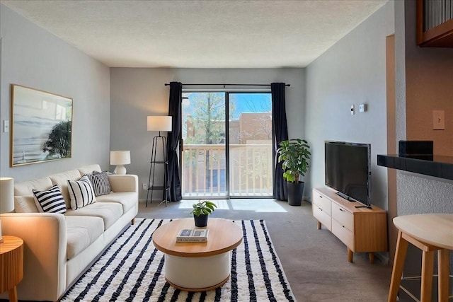 living room featuring carpet and a textured ceiling