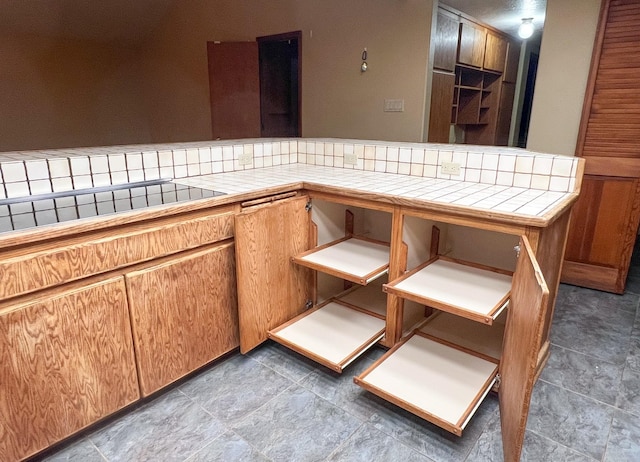 kitchen featuring tile counters and black electric stovetop