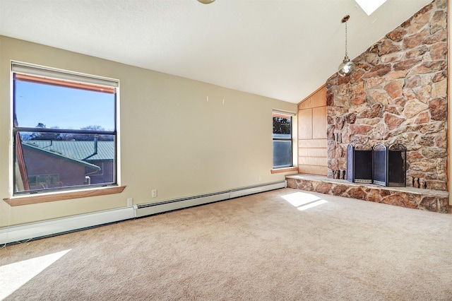 unfurnished living room featuring a stone fireplace, baseboard heating, plenty of natural light, and carpet floors