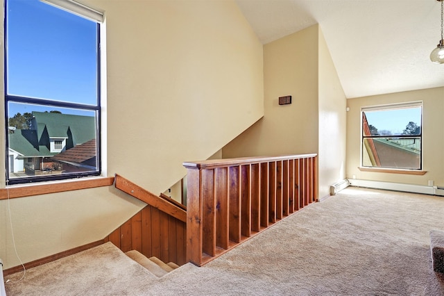 staircase with lofted ceiling, carpet floors, baseboard heating, and baseboards