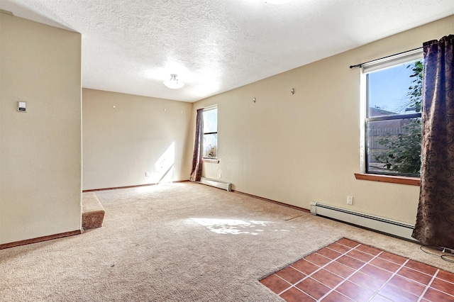 carpeted empty room featuring a baseboard radiator, baseboards, and a textured ceiling