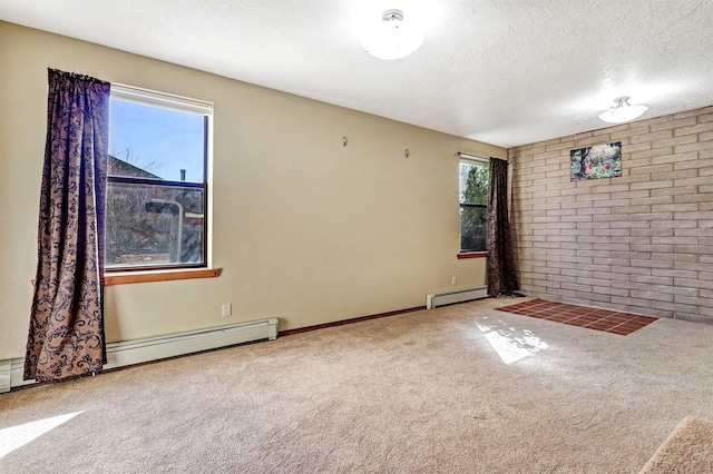 carpeted empty room with brick wall, a baseboard radiator, and a textured ceiling