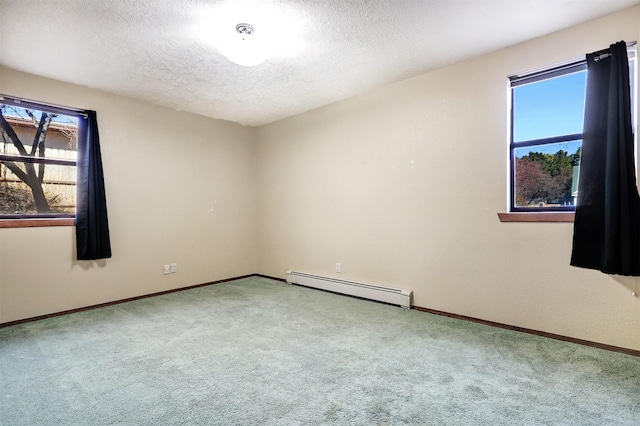 carpeted spare room featuring a baseboard radiator, baseboards, and a textured ceiling