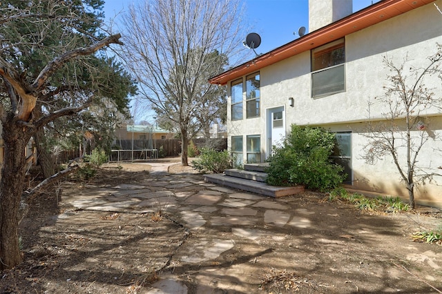 back of house featuring a patio area, a fenced backyard, and stucco siding