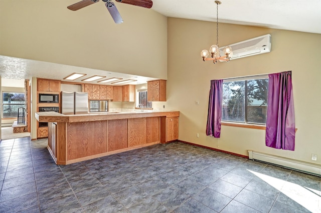 kitchen with light countertops, baseboards, a peninsula, and black appliances