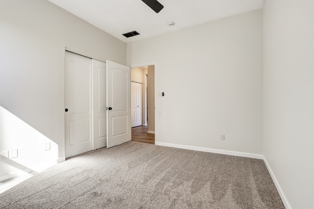 unfurnished bedroom with baseboards, visible vents, ceiling fan, carpet floors, and a closet