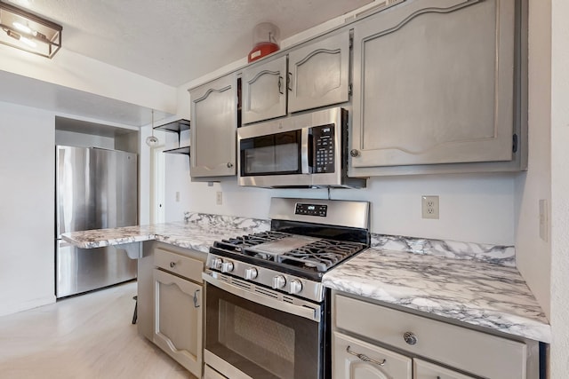 kitchen featuring appliances with stainless steel finishes and light wood-style flooring