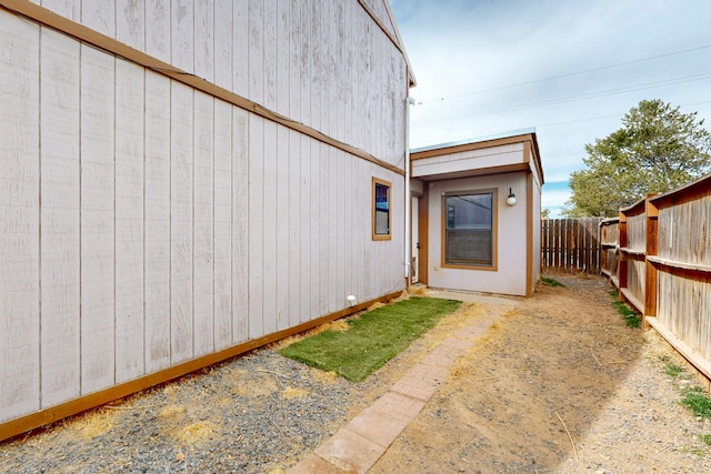 doorway to property featuring fence