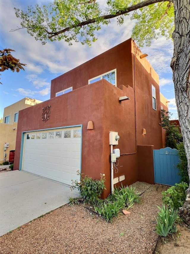 3228 El Trebol, Santa Fe, NM 87507 - view of side of home with stucco siding and driveway