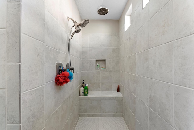 bathroom with tiled shower