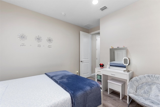 bedroom featuring visible vents and light wood finished floors