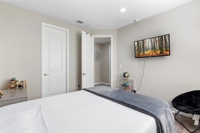 bedroom featuring visible vents and baseboards