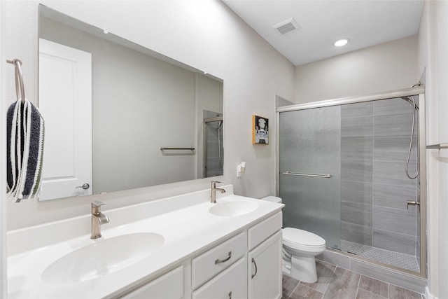 full bath featuring a stall shower, visible vents, and a sink