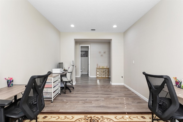 office with baseboards, visible vents, wood finished floors, and recessed lighting