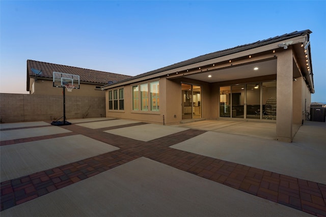 back of property featuring a patio area, fence, and stucco siding