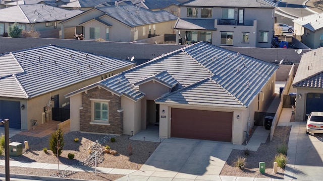 view of front of property with a residential view, stone siding, and a tiled roof