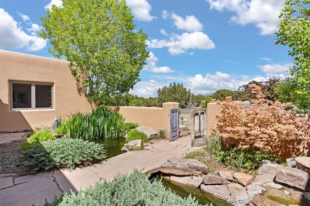 view of yard featuring a fenced front yard and a gate
