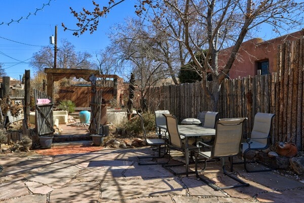 220 Irvine Unit B, Santa Fe, NM 87501 - fenced backyard featuring outdoor dining space and a patio area