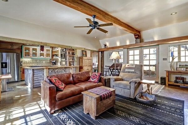220 Irvine Unit B, Santa Fe, NM 87501 - living room featuring finished concrete floors, a ceiling fan, and beam ceiling