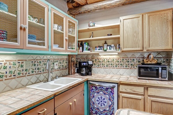 220 Irvine Unit B, Santa Fe, NM 87501 - kitchen featuring a sink, tile countertops, decorative backsplash, stainless steel appliances, and light brown cabinetry