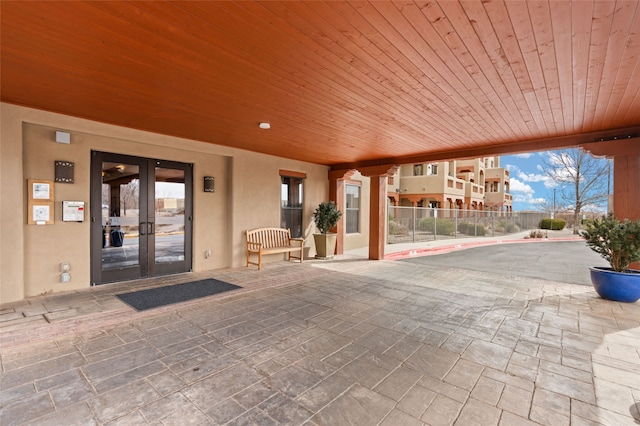 view of patio / terrace featuring french doors and fence