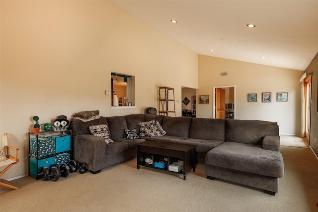 carpeted living area with high vaulted ceiling, visible vents, and recessed lighting