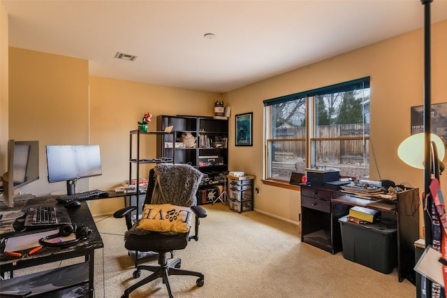 carpeted home office featuring baseboards and visible vents