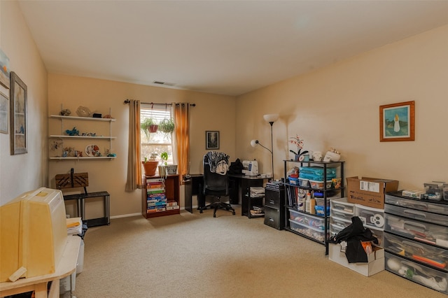 carpeted office space featuring visible vents and baseboards