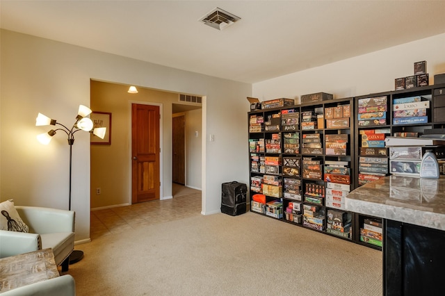 living area with carpet floors and visible vents