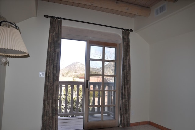 interior space featuring baseboards, visible vents, wooden ceiling, a mountain view, and beam ceiling