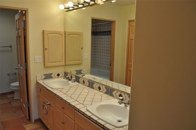 full bath with tile patterned flooring, a sink, and toilet