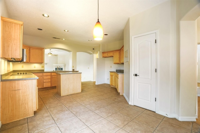 kitchen featuring arched walkways, ceiling fan, stainless steel microwave, pendant lighting, and recessed lighting