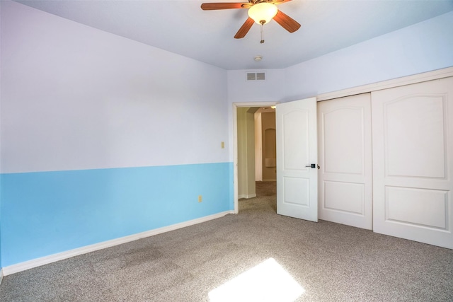 unfurnished bedroom featuring a closet, visible vents, carpet flooring, ceiling fan, and baseboards