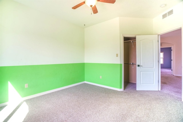 unfurnished bedroom with carpet, a closet, visible vents, and baseboards