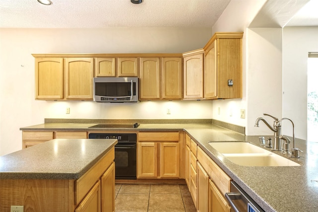 kitchen with a textured ceiling, light brown cabinetry, black appliances, a sink, and light tile patterned flooring