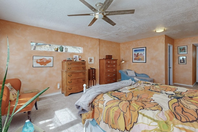 carpeted bedroom featuring ceiling fan, baseboards, and a textured ceiling