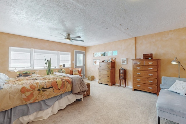 carpeted bedroom featuring multiple windows, a textured ceiling, and baseboards