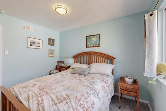 carpeted bedroom with visible vents and baseboards