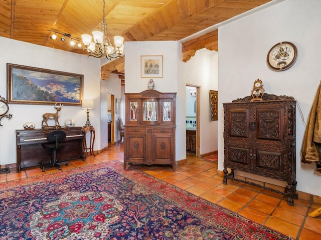 foyer with wood ceiling, a notable chandelier, baseboards, and tile patterned floors