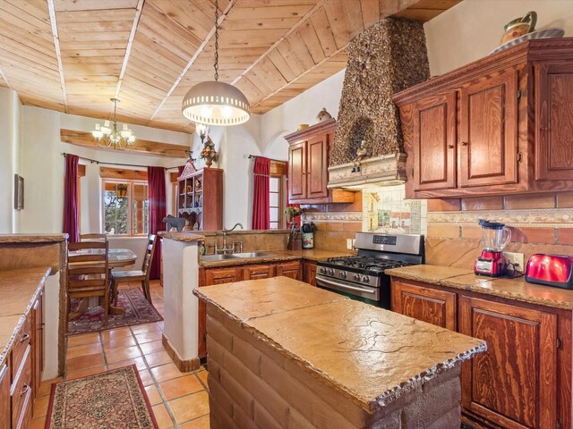 kitchen with wooden ceiling, a sink, stainless steel gas range, tasteful backsplash, and custom range hood