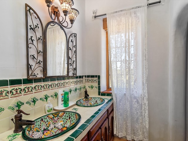 full bathroom featuring tasteful backsplash and vanity