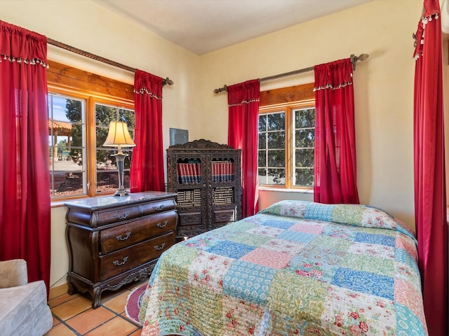 tiled bedroom featuring multiple windows