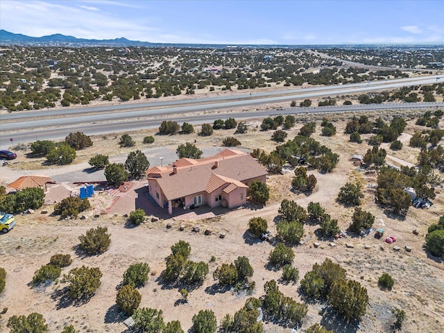 birds eye view of property featuring view of desert and a mountain view