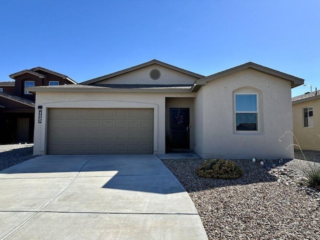 ranch-style house with a garage, concrete driveway, and stucco siding