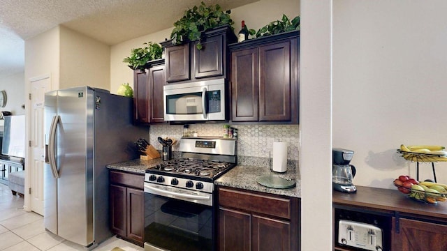 kitchen featuring appliances with stainless steel finishes, dark brown cabinetry, backsplash, and light tile patterned floors