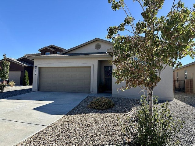 ranch-style home featuring driveway, an attached garage, and stucco siding